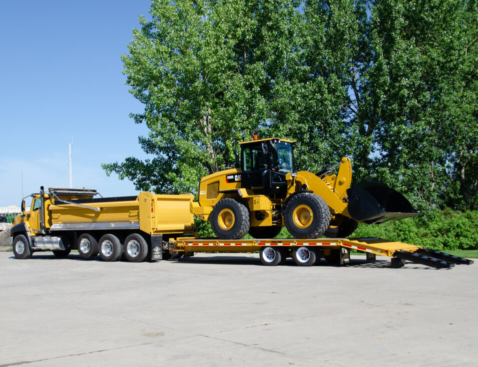 Cat truck loaded with Cat equipment