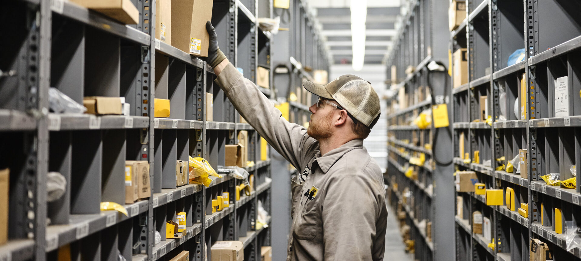 Employee retrieving parts from the warehouse shelf