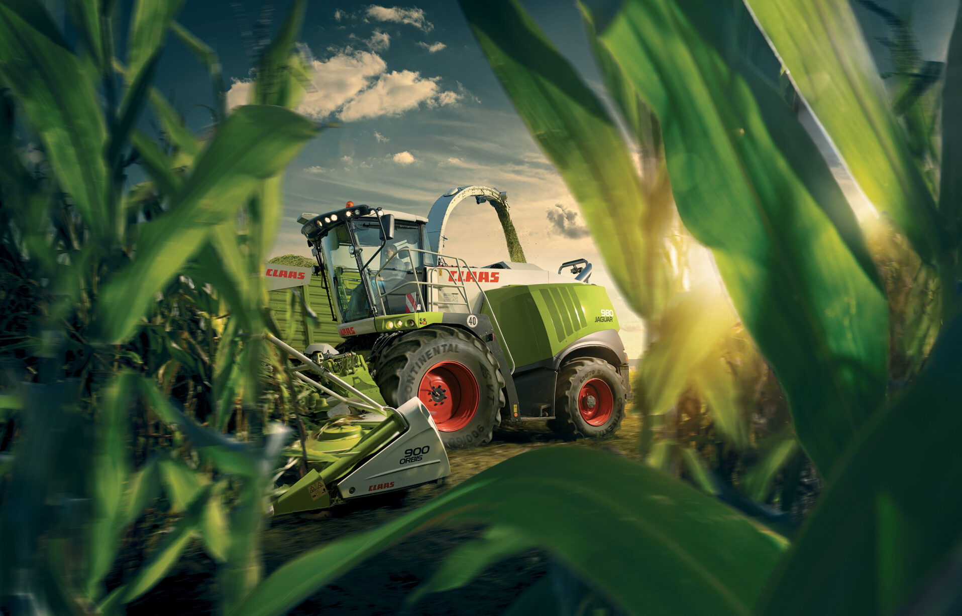 Beauty shot of CLAAS equipment working in a cornfield