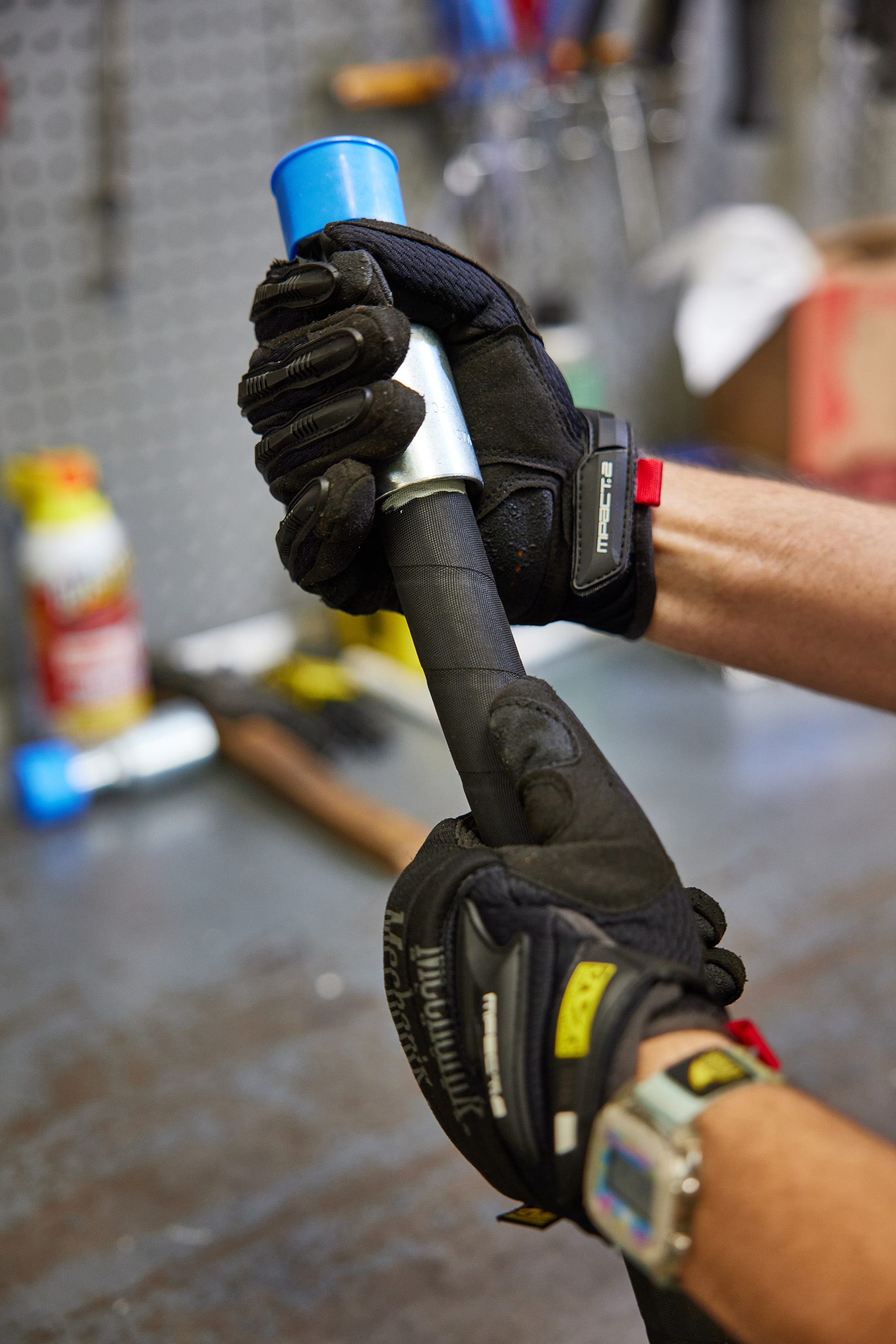 Closeup of hands working on a custom hose