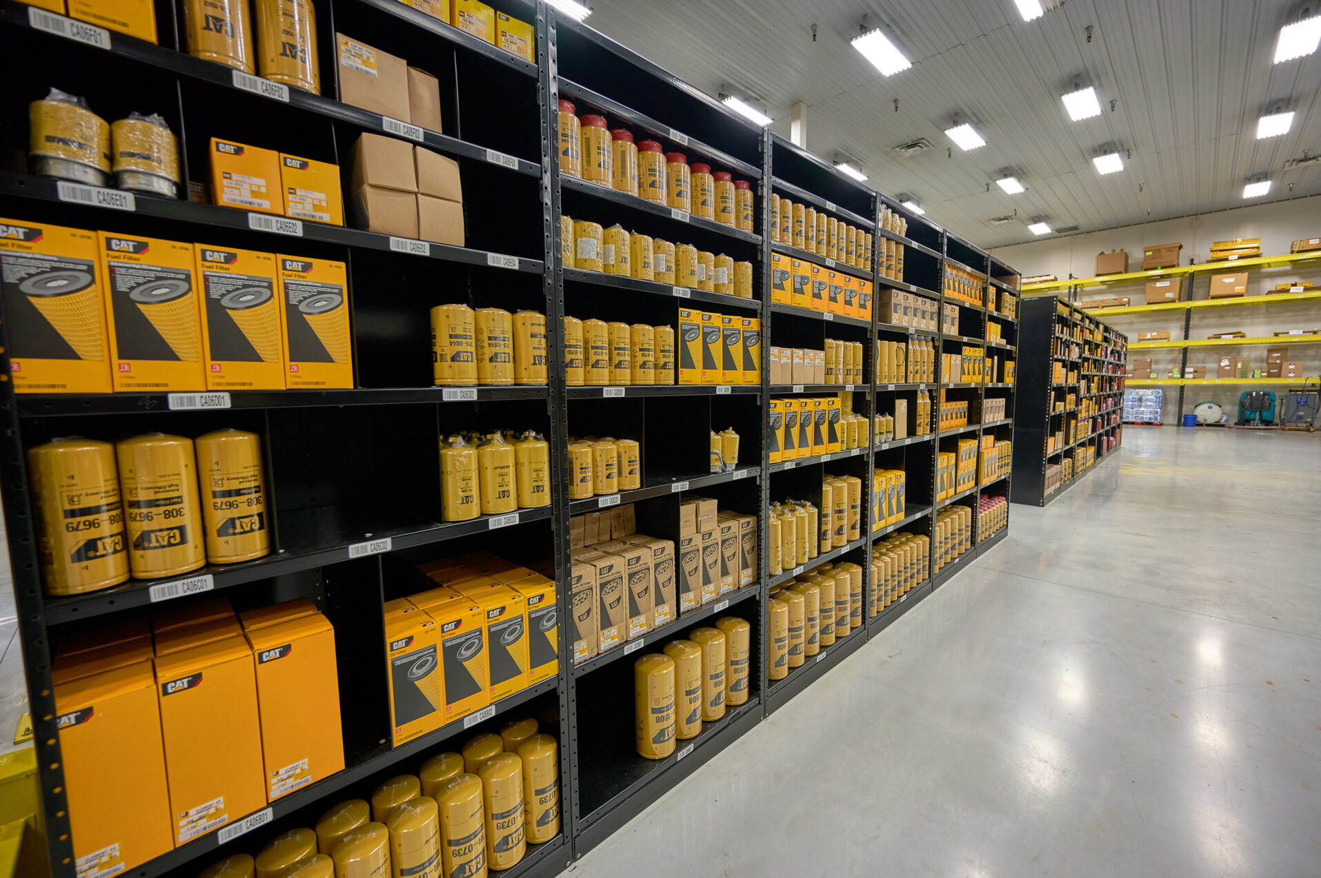 Organized shelves of Caterpillar equipment parts