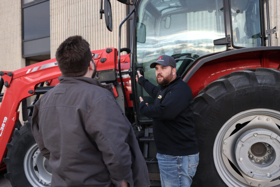 Man showing equipment to another man.