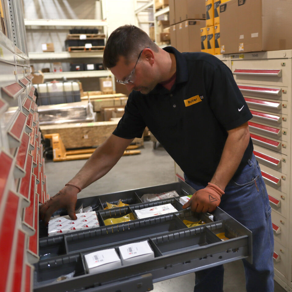 Butler employee looking through an organized drawer of small parts