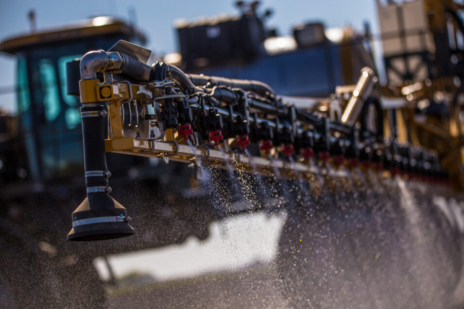 Closeup of RoGator spraying chemicals on a field