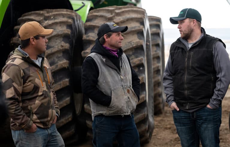 Butler Ag employee talking to two customers